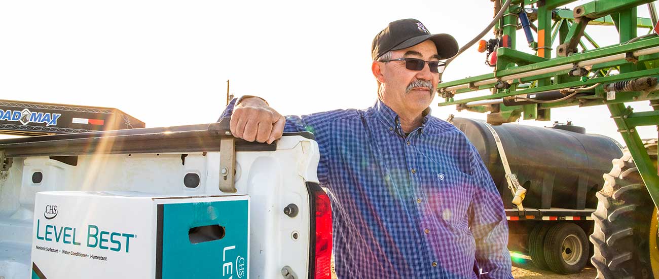 man standing next to truck with box of level best 