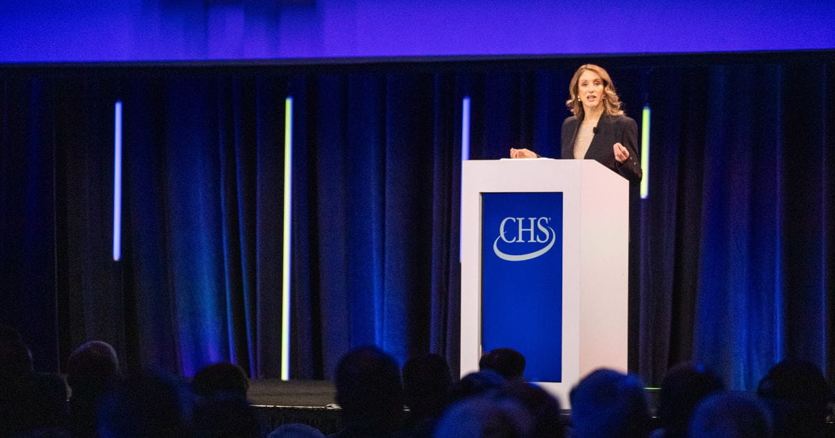 Olivia Nelligan speaking on stage at the 2025 CHS Annual Meeting